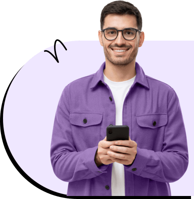 Young man with glasses holding his phone with excitement.